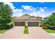 Charming villa with a two-car garage, tile roof, and manicured landscaping at 6327 Positano Ct, Sarasota, FL 34243