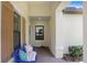 Cozy front porch with seating, decorative pillows, and brick pavers leading to the entrance at 6327 Positano Ct, Sarasota, FL 34243