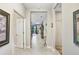 Bright hallway with tile flooring, neutral walls, and doorways leading to various rooms at 6327 Positano Ct, Sarasota, FL 34243