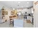 Bright kitchen with white cabinets, stainless steel appliances, and granite island with seating at 6327 Positano Ct, Sarasota, FL 34243