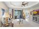 Cozy living room with a view of the lanai, tray ceilings, and comfortable seating at 6327 Positano Ct, Sarasota, FL 34243