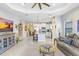 Open-concept living space with a living room, kitchen, and dining area with abundant natural light at 6327 Positano Ct, Sarasota, FL 34243