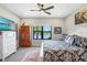 Comfortable primary bedroom with a view of the water, ceiling fan, and ample natural light at 6327 Positano Ct, Sarasota, FL 34243