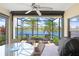 Relaxing screened patio with ceiling fan, view of the lake and comfortable seating at 6327 Positano Ct, Sarasota, FL 34243