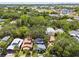 An aerial view of a neighborhood featuring mature trees and a charming blue home at 711 S Bungalow Ter, Tampa, FL 33606