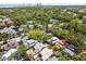 An aerial view of a neighborhood featuring mature trees and a charming blue home in distance at 711 S Bungalow Ter, Tampa, FL 33606