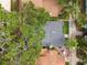 Aerial view of a house with a large tree and fenced yard at 711 S Bungalow Ter, Tampa, FL 33606