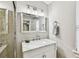Bathroom featuring single vanity with granite counters, modern fixtures, and a glass shower at 711 S Bungalow Ter, Tampa, FL 33606