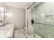 Stylish bathroom featuring double sinks with granite counters, modern fixtures, and a tiled glass shower at 711 S Bungalow Ter, Tampa, FL 33606