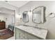 Bright bathroom featuring double sinks with granite counters, modern fixtures, and a shower in view at 711 S Bungalow Ter, Tampa, FL 33606