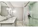 Bathroom featuring double sinks with granite counters, modern fixtures, and a tiled glass shower at 711 S Bungalow Ter, Tampa, FL 33606