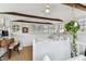 Upstairs bedroom featuring wood beams, many windows, and hardwood floors at 711 S Bungalow Ter, Tampa, FL 33606