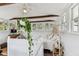 Upstairs bedroom featuring wood beams, many windows, and hardwood floors and plants at 711 S Bungalow Ter, Tampa, FL 33606