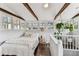 Upstairs bedroom featuring wood beams, many windows, hardwood floors and lots of plants at 711 S Bungalow Ter, Tampa, FL 33606