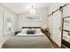 Bedroom features stylish decor, plush bedding, and a unique window design at 711 S Bungalow Ter, Tampa, FL 33606