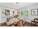 Open dining room flowing into kitchen with hardwood floors and natural light at 711 S Bungalow Ter, Tampa, FL 33606