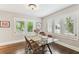 Bright dining room featuring hardwood floors, light fixture, and white trim at 711 S Bungalow Ter, Tampa, FL 33606