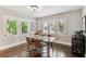 Sunlit dining room with hardwood floors and plantation shutters on windows at 711 S Bungalow Ter, Tampa, FL 33606