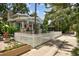 Charming blue two-story home with stone accents, white picket fence, and lush landscaping at 711 S Bungalow Ter, Tampa, FL 33606