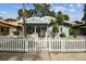 Charming light blue bungalow with a white picket fence and stone accents at 711 S Bungalow Ter, Tampa, FL 33606