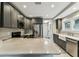 Bright kitchen features gray cabinets, stainless steel appliances, marble countertops, and tiled floors at 711 S Bungalow Ter, Tampa, FL 33606