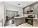 Kitchen view into dining area with modern appliances and cabinetry at 711 S Bungalow Ter, Tampa, FL 33606