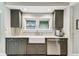Bright kitchen with stainless steel dishwasher and farmhouse sink at 711 S Bungalow Ter, Tampa, FL 33606