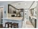 Modern kitchen with stainless steel appliances and gray cabinetry and counter seating at 711 S Bungalow Ter, Tampa, FL 33606