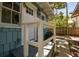 Side porch entrance of charming blue home with white railing and shingle siding at 711 S Bungalow Ter, Tampa, FL 33606