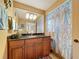 Bathroom featuring a granite counter, tile flooring, tub shower, and ample wood cabinet storage at 760 Capri Blvd, Treasure Island, FL 33706