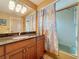Bathroom showcasing a granite counter, tile flooring, bathtub with shower, and vanity with ample storage at 760 Capri Blvd, Treasure Island, FL 33706