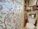 Bathroom featuring a floral shower curtain, toilet and shelves at 760 Capri Blvd, Treasure Island, FL 33706