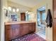Double sink bathroom with granite countertops, and dark wood cabinets at 760 Capri Blvd, Treasure Island, FL 33706