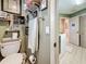 Cozy bathroom featuring neutral tones, with a toilet, and a view to a laundry area at 760 Capri Blvd, Treasure Island, FL 33706