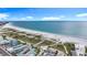 Breathtaking aerial view of the coastline showcasing expansive white sands, dunes, and the sparkling turquoise ocean waters at 760 Capri Blvd, Treasure Island, FL 33706