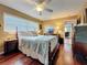 Comfortable bedroom boasts a four-poster bed, wood floors, and a view of the home interior at 760 Capri Blvd, Treasure Island, FL 33706