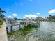 Picturesque waterfront dock with boat, providing seamless access to the open water, perfect for boating enthusiasts and coastal living at 760 Capri Blvd, Treasure Island, FL 33706