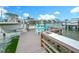 Beautiful waterfront dock with table, chairs, sink, and boat lift, perfect for enjoying the coastal lifestyle at 760 Capri Blvd, Treasure Island, FL 33706