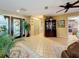 Inviting foyer with tile flooring, a decorative cabinet, and a view leading to the kitchen at 760 Capri Blvd, Treasure Island, FL 33706