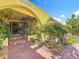 Inviting arched entry showcasing beautiful brickwork, lush plants and a welcoming facade at 760 Capri Blvd, Treasure Island, FL 33706