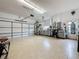 Spacious garage with tile flooring, ample storage cabinets, and room for multiple vehicles at 760 Capri Blvd, Treasure Island, FL 33706