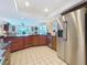Well-equipped kitchen with stainless steel refrigerator, dark countertops, and views of the water at 760 Capri Blvd, Treasure Island, FL 33706