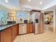 Kitchen boasts stainless steel appliances, granite countertops, wooden cabinets, and bright lighting at 760 Capri Blvd, Treasure Island, FL 33706