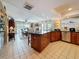 Open kitchen with dark countertops, wood cabinets, stainless steel appliances, and a large island at 760 Capri Blvd, Treasure Island, FL 33706