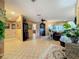 Open-concept living room featuring tile flooring, neutral walls, and ample natural light at 760 Capri Blvd, Treasure Island, FL 33706
