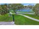 Well-maintained tennis and shuffleboard courts with lush green surroundings and blue courts for a relaxing game at 760 Capri Blvd, Treasure Island, FL 33706