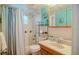 Cozy bathroom featuring a vanity, toilet, tub, and shower with a blue and white striped curtain at 7699 92Nd St, Seminole, FL 33777