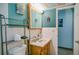 Bathroom with a vanity, a toilet, and teal-painted walls and unique decor at 7699 92Nd St, Seminole, FL 33777