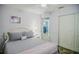 Calming bedroom with a sliding closet door and doorway to another room visible at 7699 92Nd St, Seminole, FL 33777