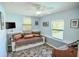 Bright room with a striped futon, two windows and multi-color slate-look flooring at 7699 92Nd St, Seminole, FL 33777